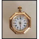 A stamped 14ct gold pocket fob watch of octagonal form having engraved floral decoration with