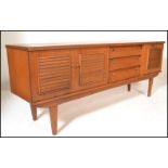 A retro 20th Century Danish inspired teak wood sideboard credenza, the sideboard having a bank of