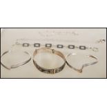 A group of silver bracelets to include a Mexican panel bracelet, two ripple design brangles, a chain