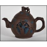 A 20th Century Chinese Yixing brown clay teapot having handle and spout modelled as a tree trunk