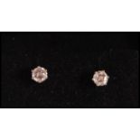 A pair of 18ct white gold stud earrings prong set with two brilliant cut diamonds. Weight 0.9g.