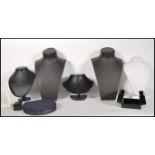 A collection of jewellery necklace counter top display stands upholstered in black and white leather