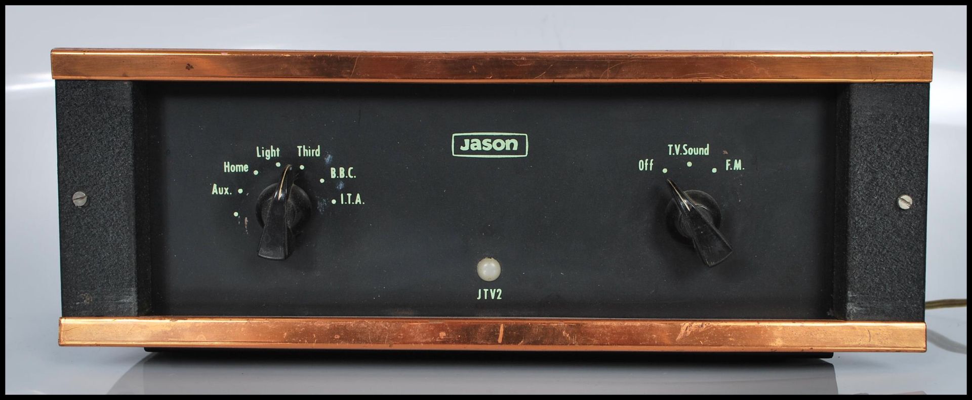 A vintage Jason JTV2 sound amplifier unit having copper mounts.