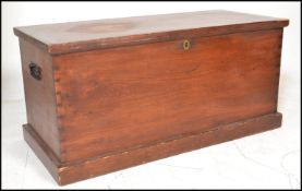 A 20th Century stained pine blanket box having metal twin carrying handles to both sides, to
