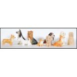 A collection of vintage 20th Century ceramic dog figurines by Sylvac to include Alsatian, Corgis,