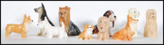 A collection of vintage 20th Century ceramic dog figurines by Sylvac to include Alsatian, Corgis,