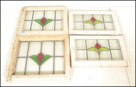 A set of four early 20th Century Edwardian stained glass windows having lead lined glass panels with