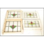 A set of four early 20th Century Edwardian stained glass windows having lead lined glass panels with