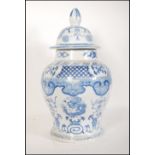 A tall 20th Century Chinese blue and white lidded ginger jar of bulbous form. The jar transfer