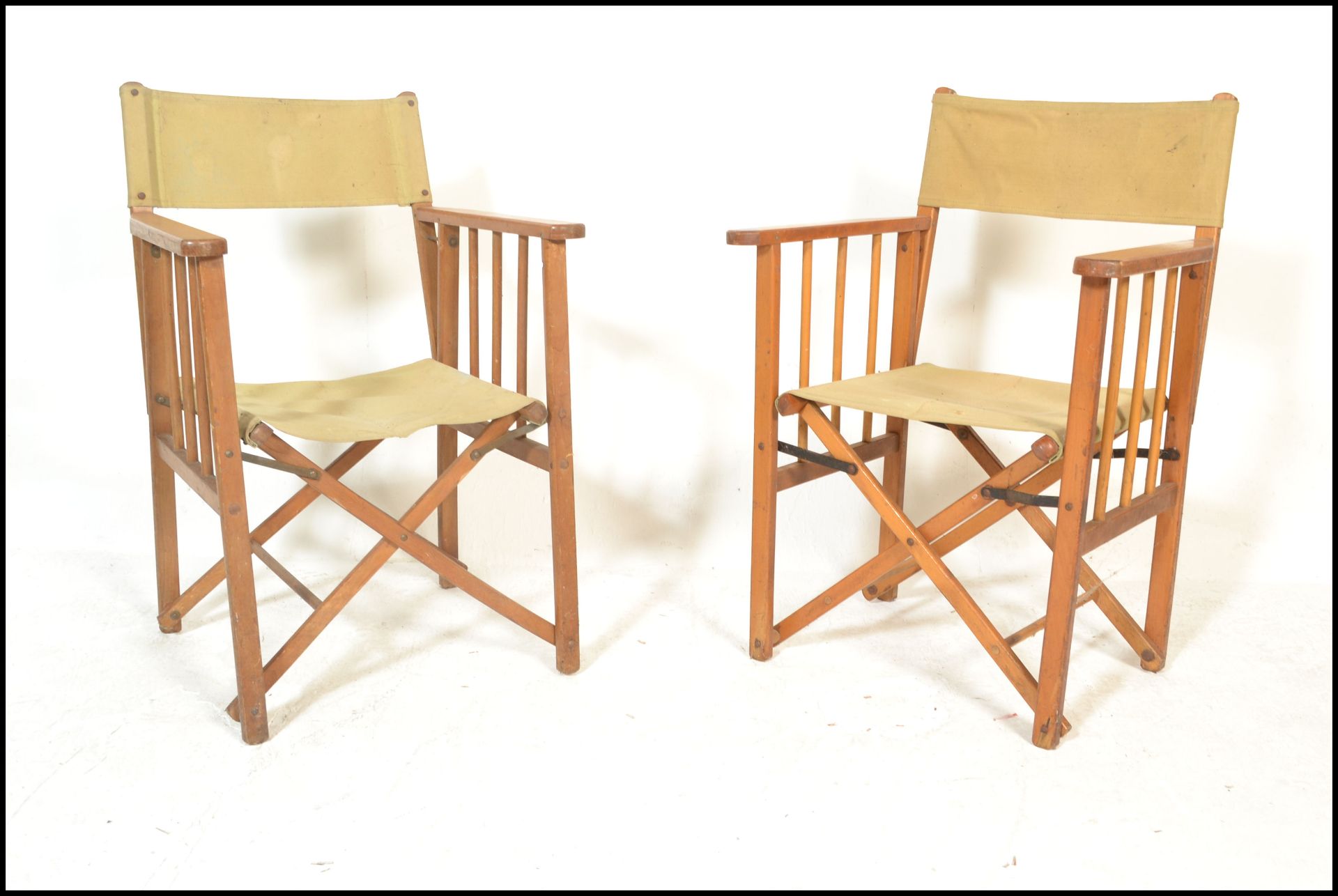 A group of four retro mid 20th Century wooden and canvas upholstered directors / garden chairs,