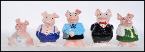 A set of five graduating 20th Century savers collectable Natwest pigs by Wade, fitted stoppers and