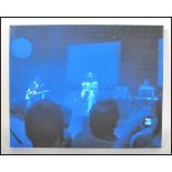 A photographic canvas depicting Portishead on stage featuring Beth Gibbons at the microphone.