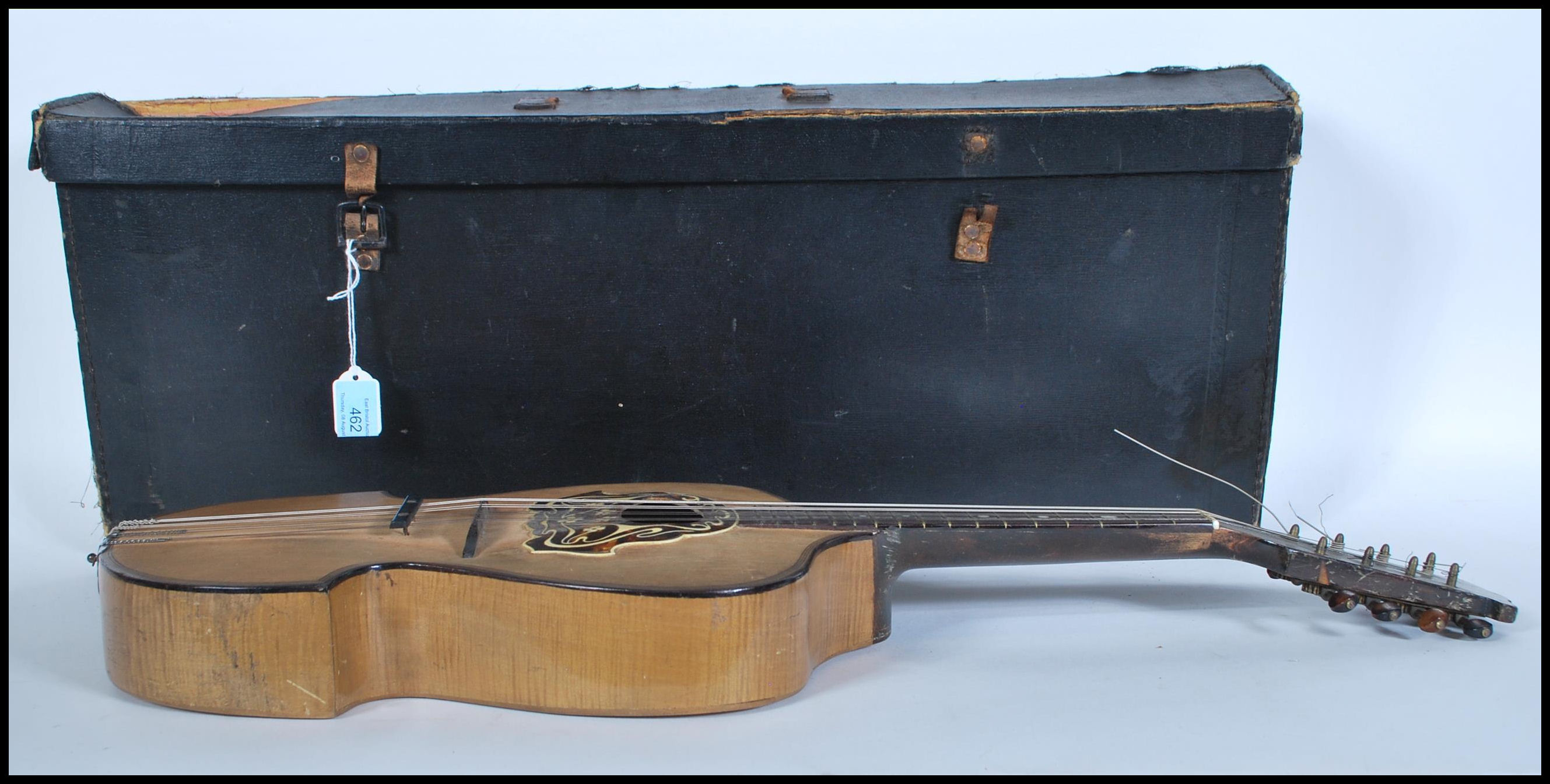 An early 20th Century Mandolin having mother of pearl inlaid fingerboard with bone and tortoiseshell