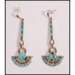 A pair of stamped 925 silver Art Deco style drop earrings being set with turquoise panels and