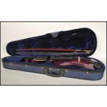 A 20th Century cased student violin, the hollow body having an Aubergine purple finish, cased with