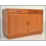 A 20th Century Danish teak wood sideboard / credenza having a configuration of two drawers over