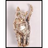 A stamped 925 silver brooch in the form of a cat set with emerald eyes. Weight 7.7g. measures 3.