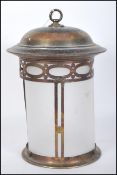 A early 20th Century Edwardian Arts & Crafts pierced brass framed cylindrical hall lantern with