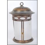 A early 20th Century Edwardian Arts & Crafts pierced brass framed cylindrical hall lantern with