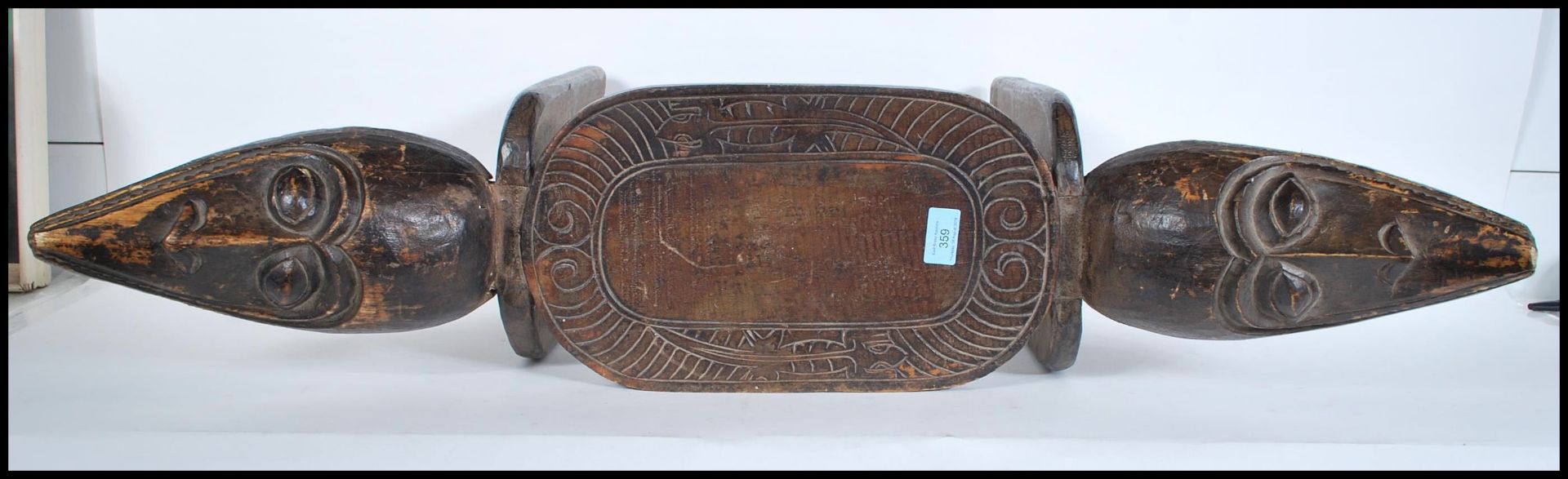 A vintage African carved tribal stool, the seat pad with chase decoration carvings flanked by carved - Bild 4 aus 4