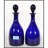 A pair of 20th century Bristol blue glass spirit decanters with stoppers, each with ball finial