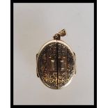 A 9ct gold hallmarked unusual double door locket being chase decorated with twin doors and bale