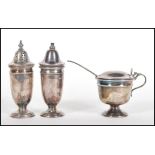 A mid 20th Century silver hallmarked condiment cruet set consisting of salt and pepper shakers /