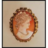 An early 20th century 9ct gold mounted cameo pendant / brooch. The brooch having a carved shell