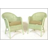 A matching pair of 20th Century wicker Lloyd Loom bedroom armchairs finished in light green having