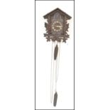 A 19th Century wall hanging Black Forest style cuckoo clock of architectural form, having white