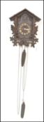 A 19th Century wall hanging Black Forest style cuckoo clock of architectural form, having white