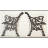 A pair of 20th Century cast iron scroll work garden bench ends together with a pair of metal