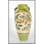 William Baron for CH Brannam Pottery 1891. A tall three handled vase of bulbous form with waisted
