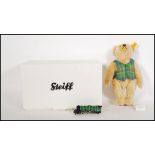 A boxed Steiff mohair teddy bear 004230 'Flying Scotsman' wearing a green scottish waistcoat, having