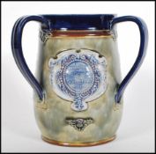 An early 20th century Royal Doulton three handled large loving cup commemorating '  The Coronation