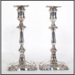 A pair of 20th Century Martin Hall & co silver plated candlesticks of rococo form being cast in