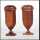 A pair of Georgian turned wooden gambling dice cups / shakers being raised on turned plinth bases