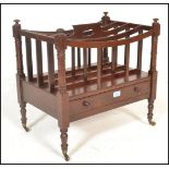 A 20th Century Regency style mahogany Canterbury magazine rack being raised on turned legs with