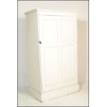 An early 20th century painted pine housekeepers cupboard / wardrobe. Raised on a plinth base with