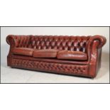 A 20th century Oxblood leather chesterfield button back sofa settee. The sofa with button backing to