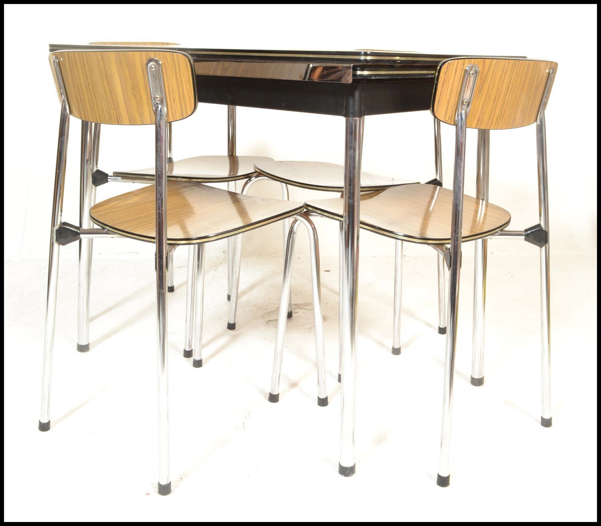 An original  retro 1970's Belgian Tavo dining table raised on chrome supports  extending table top