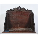 A late 19th Century Victorian oak table book trough having carved decoration throughout with shell