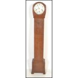 An early 20th Century Edwardian oak cased long case grandmother clock having a round white enamelled