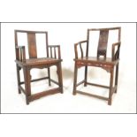 A pair of believed 19th / 20th century Chinese armchairs / elbow chairs. One having solid seat pad