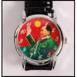 A gentleman's wrist watch, the face printed with an image of Chairman Mao with an articulated waving