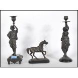 Two late 19th Century Continental spelter near matching candlesticks modelled in the form of a