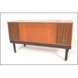 A vintage retro teak cased His Masters Voice radiogram opening to reveal a WYE electronic turntable,