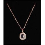 A stamped 18ct white gold necklace having a fine link chain with a sapphire pendant set diamond