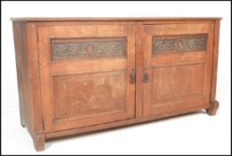 A late 19th Century Victorian low oak sideboard cassone style dresser base  having carved panel