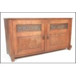 A late 19th Century Victorian low oak sideboard cassone style dresser base  having carved panel